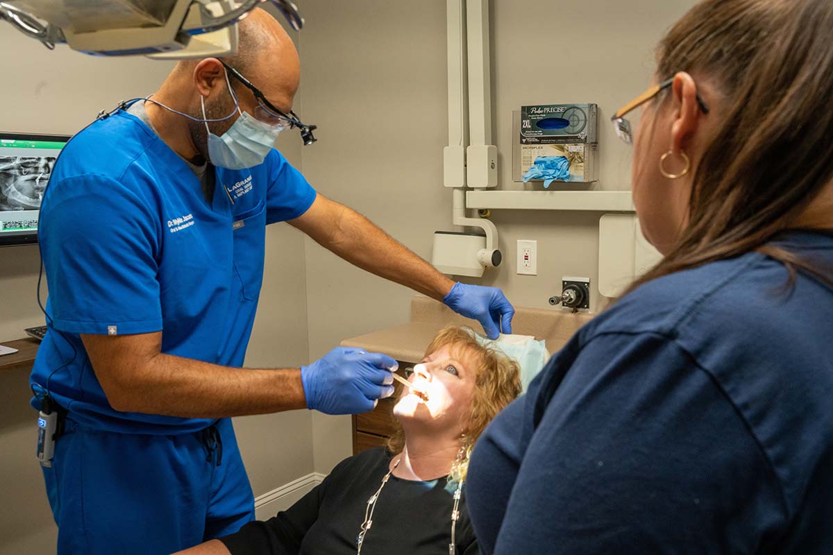 Dr. Mykle Jacobs examines a patient's mouth at LaGrange Oral Surgery and Implant Center.