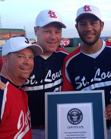 Dr. Mykle Jacobs poses with his Guinness Book of World Record plaque after playing in the World's Longest Baseball Game.