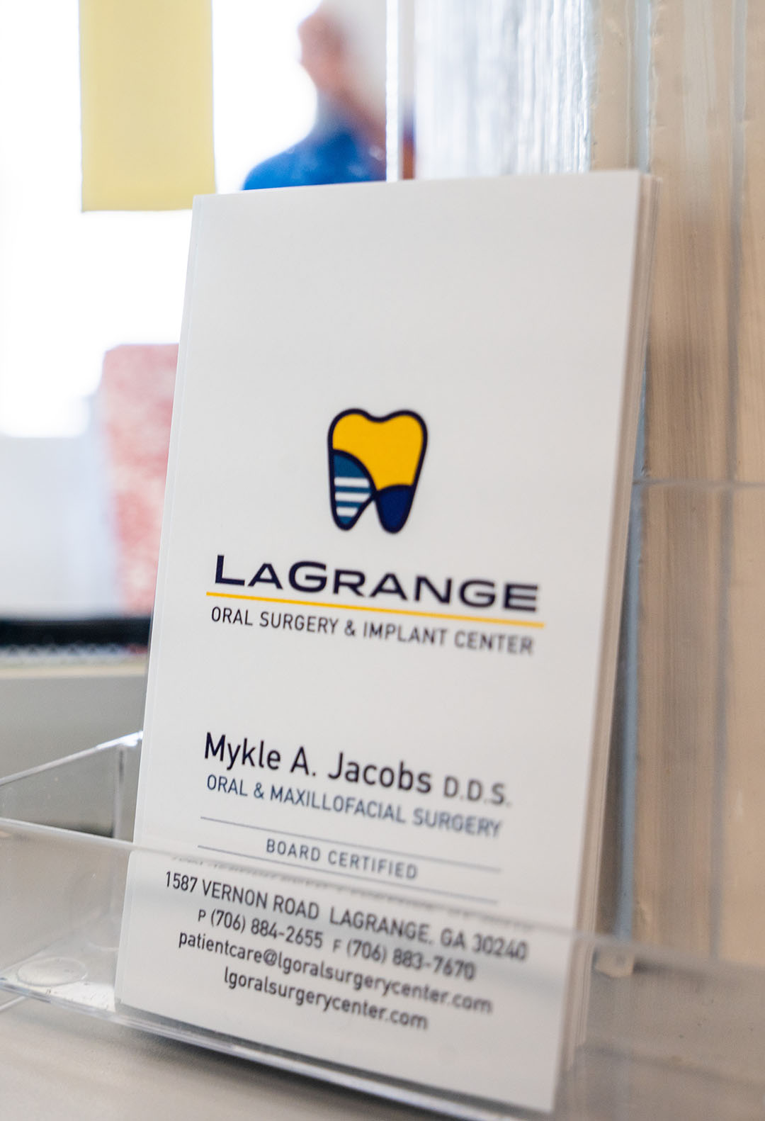 A rack card with Dr. Mykle Jacobs' information on display at LaGrange Oral Surgery and Implant Center.