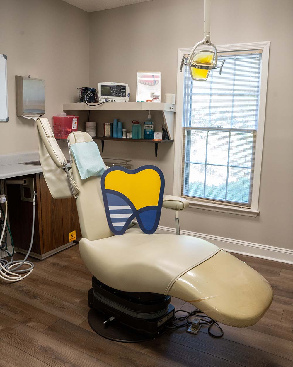 The logo mark of LaGrange Oral Surgery and Implant Center placed on an exam chair.
