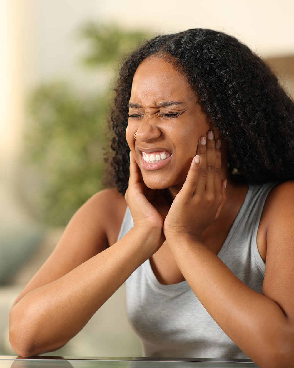 A woman dealing with tooth and jaw pain.